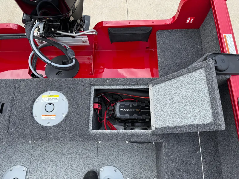 Slide: The Image of 2025 Lund 1650 Rebel XL SS boat interior with open battery compartment and red accents. - 18