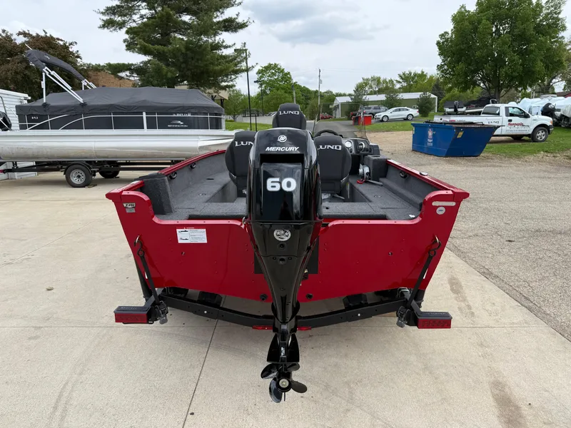 Slide: The Image of 2025 Lund 1650 Rebel XL SS boat with Mercury 60 engine, parked outdoors. - 5