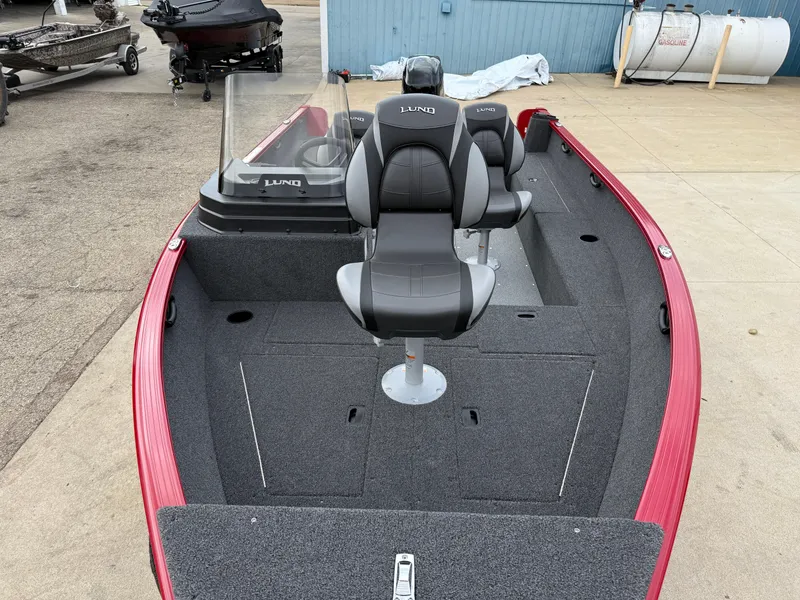 Slide: The Image of 2025 Lund 1650 Rebel XL SS boat with red exterior and gray interior seating. - 7