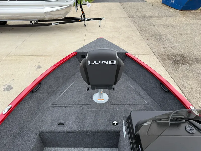 Slide: The Image of 2025 Lund 1650 Rebel XL SS boat interior with red trim and branded seat. - 9