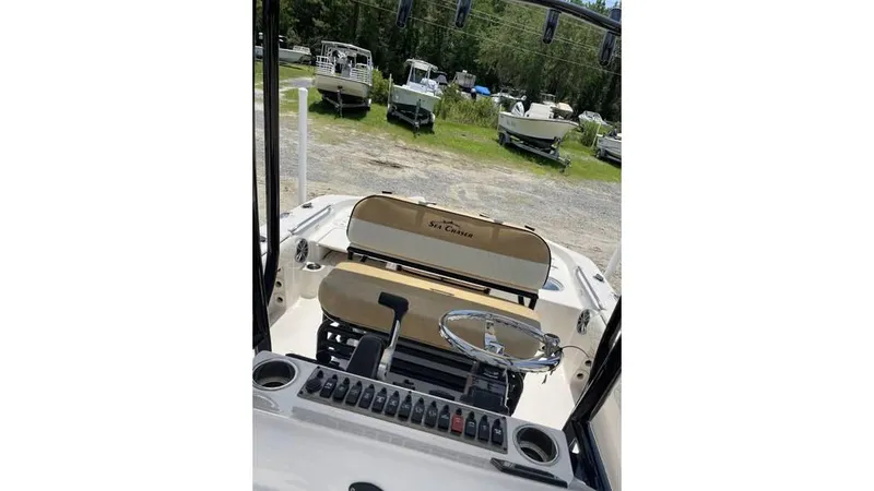 Slide: The Image of 2023 Sea Chaser 23 LX boat interior with steering wheel and control panel. - 10