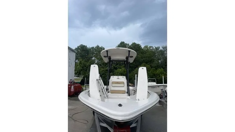 Slide: The Image of 2023 Sea Chaser 23 LX boat, front view, parked outdoors under cloudy sky. - 8