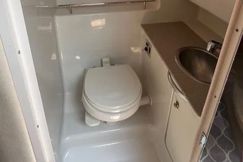 Slide: The Image of 2007 Sea Ray 290 Sundancer bathroom with toilet, sink, and countertop. - 11