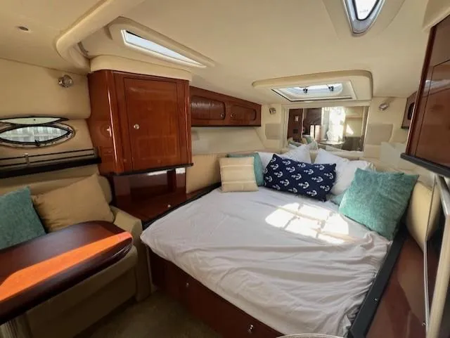 Slide: The Image of Luxurious 2007 Sea Ray 290 Sundancer cabin with cozy bed and elegant wood finishes. - 12