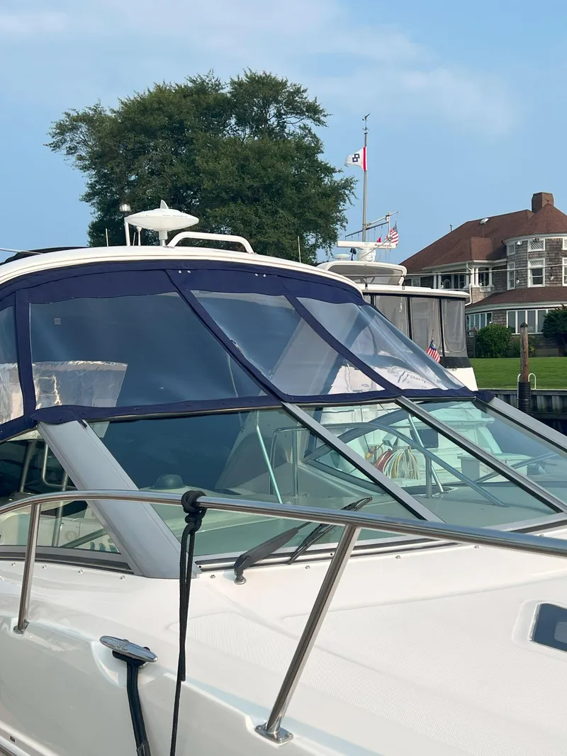 Slide: The Image of 2007 Sea Ray 290 Sundancer boat docked near waterfront property. - 3