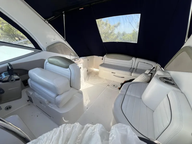 Slide: The Image of 2007 Sea Ray 290 Sundancer interior with white seating and blue canopy. - 6