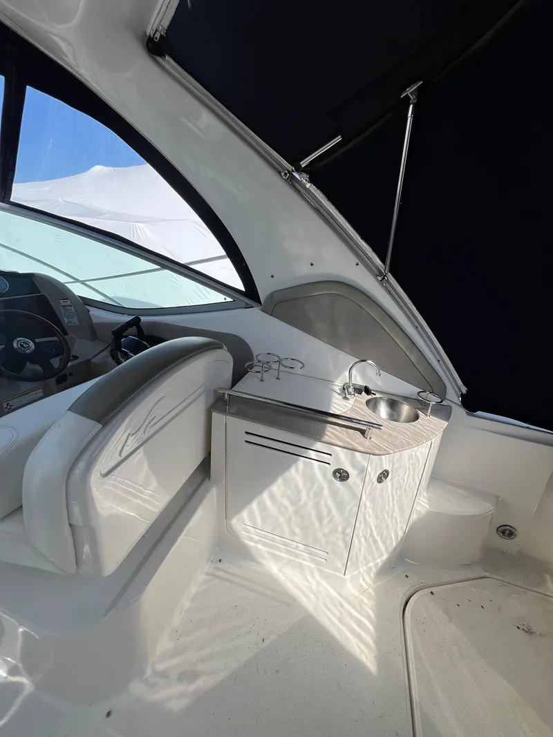 Slide: The Image of 2007 Sea Ray 290 Sundancer interior with helm and compact sink area. - 8
