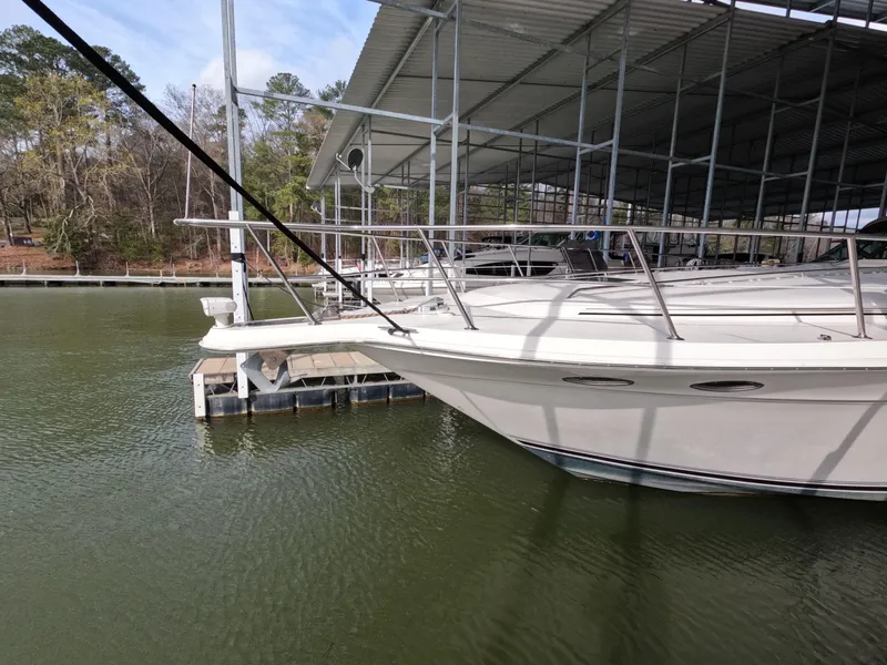 Slide: The Image of 1998 Sea Ray 500 Sundancer docked at marina under covered shelter. - 21