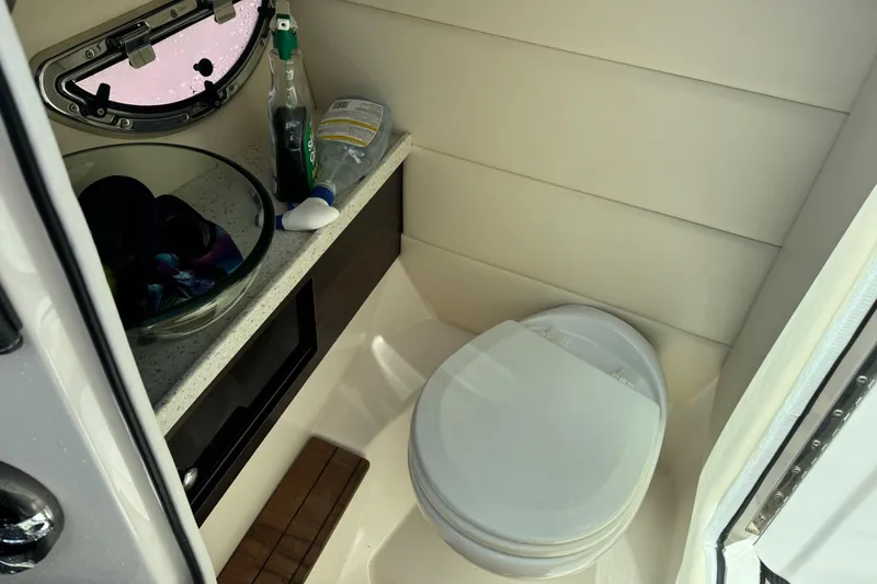 Slide: The Image of 2018 Regal 29 OBX boat bathroom with toilet and sink. - 16