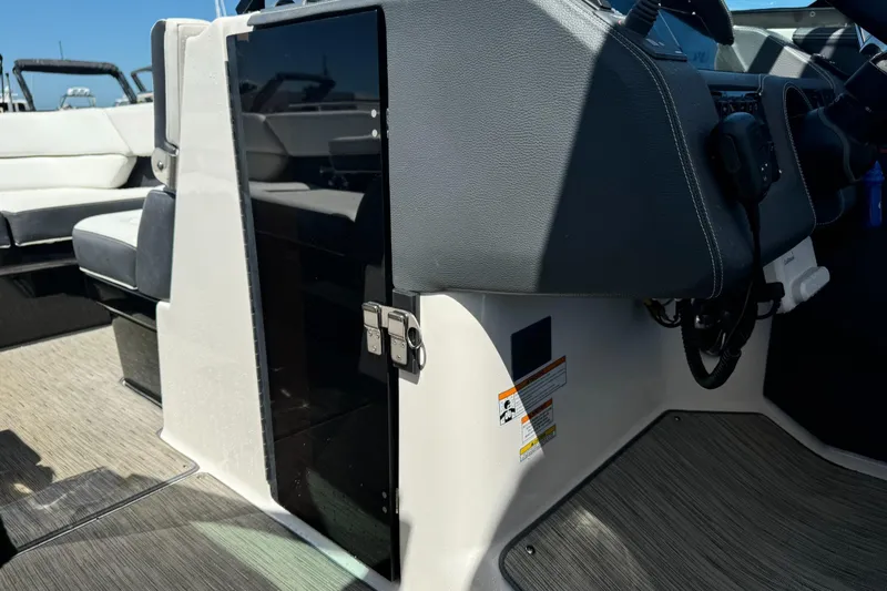 Slide: The Image of 2018 Regal 29 OBX boat interior with steering console and seating area. - 21