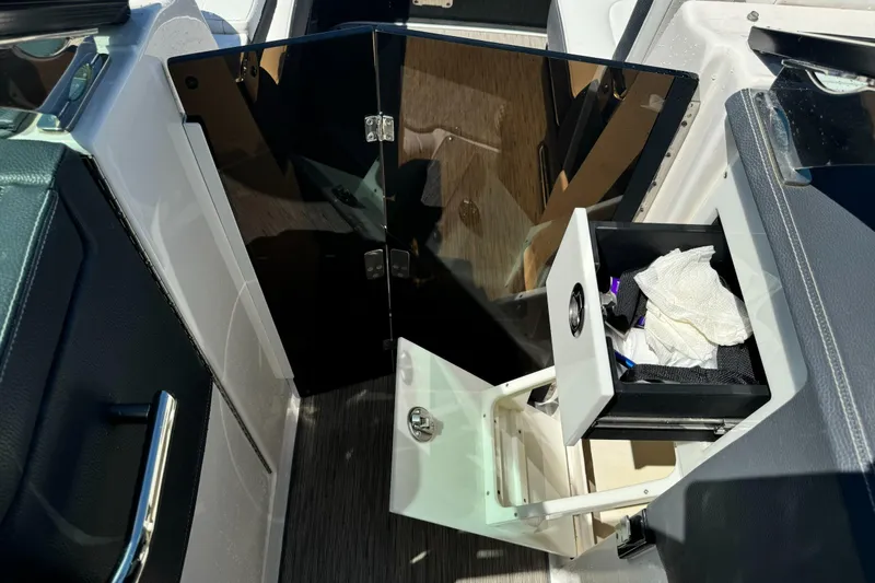 Slide: The Image of 2018 Regal 29 OBX boat interior with open storage compartments and sleek design. - 22