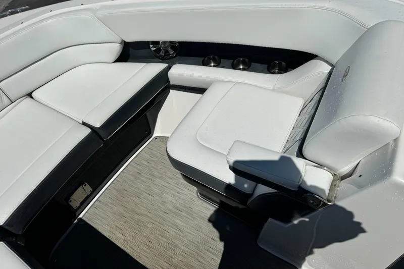 Slide: The Image of 2018 Regal 29 OBX boat interior with white cushioned seating and cup holders. - 25
