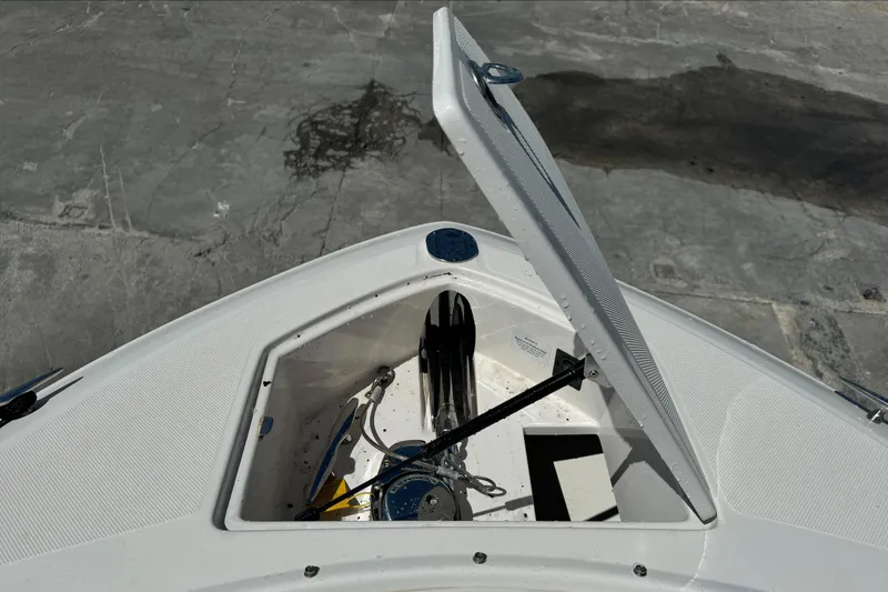Slide: The Image of Open storage compartment on 2018 Regal 29 OBX boat, showing anchor and equipment. - 27