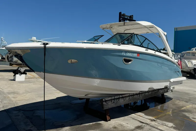 Slide: The Image of 2018 Regal 29 OBX boat on display, blue and white hull, docked outdoors. - 29