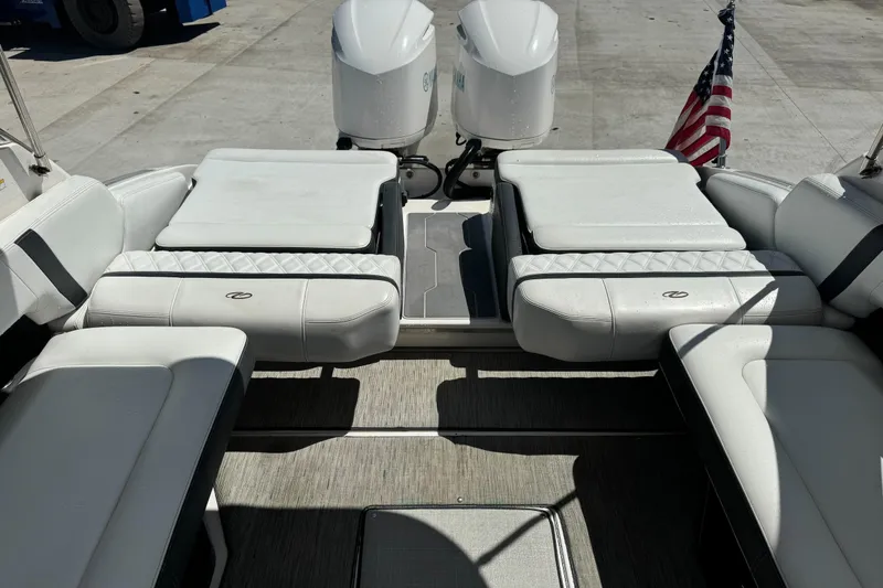 Slide: The Image of 2018 Regal 29 OBX boat interior with white seating and American flag. - 3