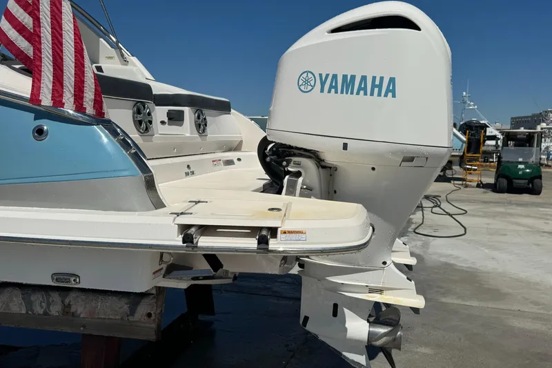 Slide: The Image of 2018 Regal 29 OBX boat with Yamaha outboard motor at a marina. - 31