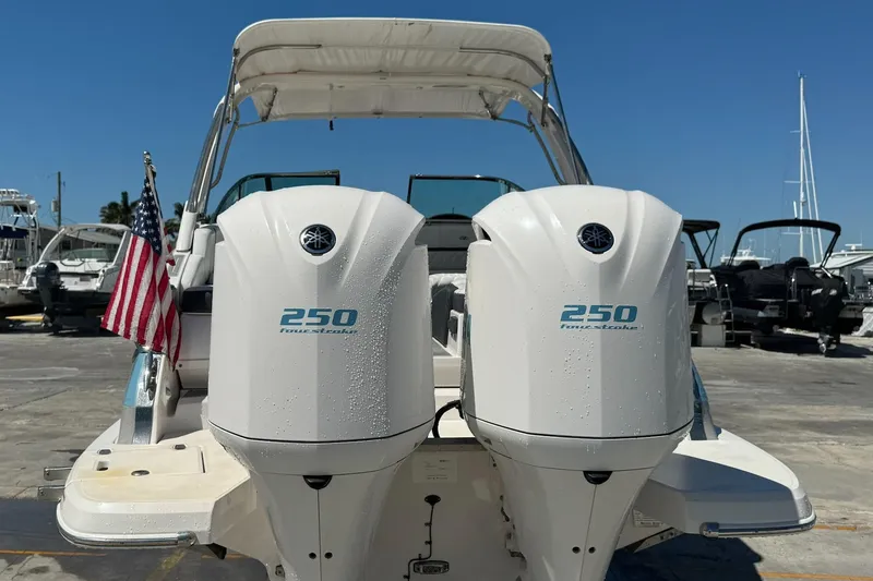 Slide: The Image of 2018 Regal 29 OBX boat with twin 250 horsepower engines and American flag. - 32