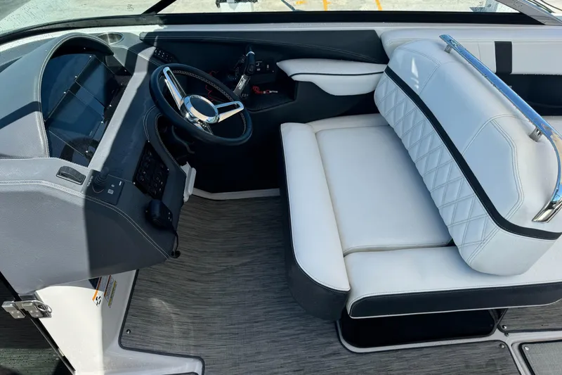 Slide: The Image of 2018 Regal 29 OBX boat interior with steering wheel and white seating. - 6