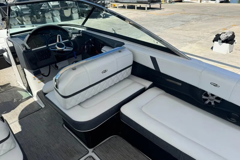 Slide: The Image of 2018 Regal 29 OBX boat interior with white seating and steering wheel. - 7