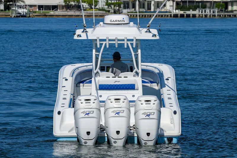 Slide: The Image of 2019 Yellowfin 34 Center Console boat with triple outboard engines on the water. - 1