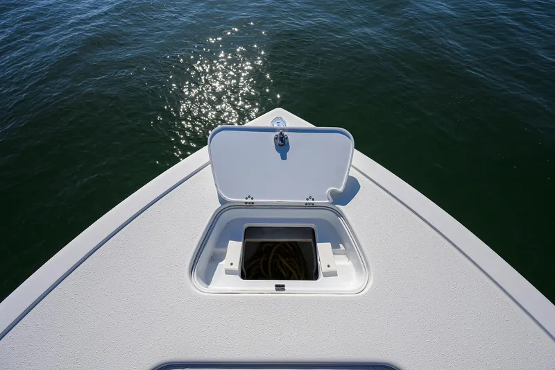 Slide: The Image of 2019 Yellowfin 34 Center Console boat with open storage hatch on calm water. - 10