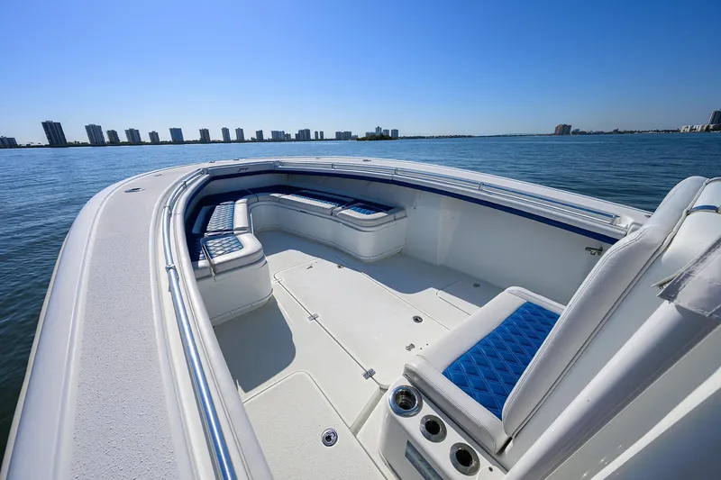 Slide: The Image of 2019 Yellowfin 34 Center Console boat on calm water, featuring spacious seating and sleek design. - 12