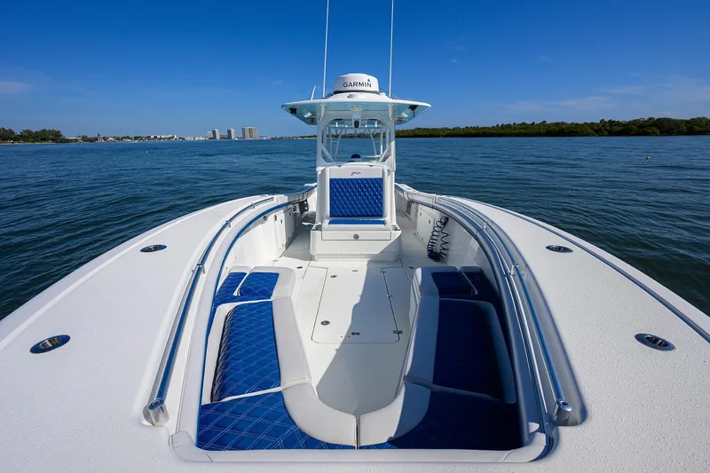 Slide: The Image of 2019 Yellowfin 34 Center Console boat on calm water, featuring blue seating. - 13