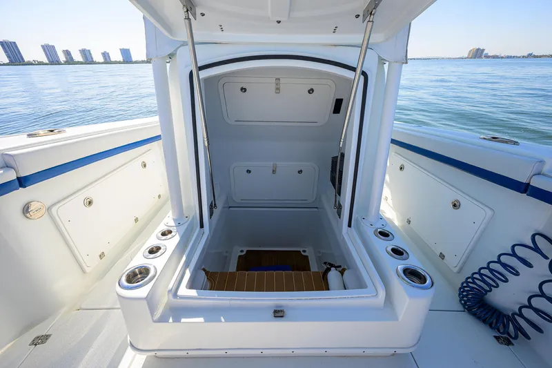 Slide: The Image of 2019 Yellowfin 34 Center Console boat interior with open hatch, ocean view. - 16