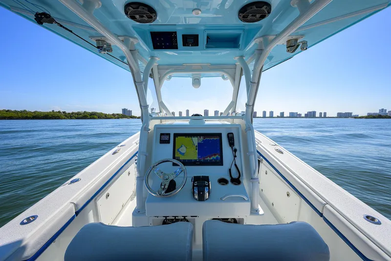 Slide: The Image of 2019 Yellowfin 34 Center Console boat on calm water, city skyline in background. - 22