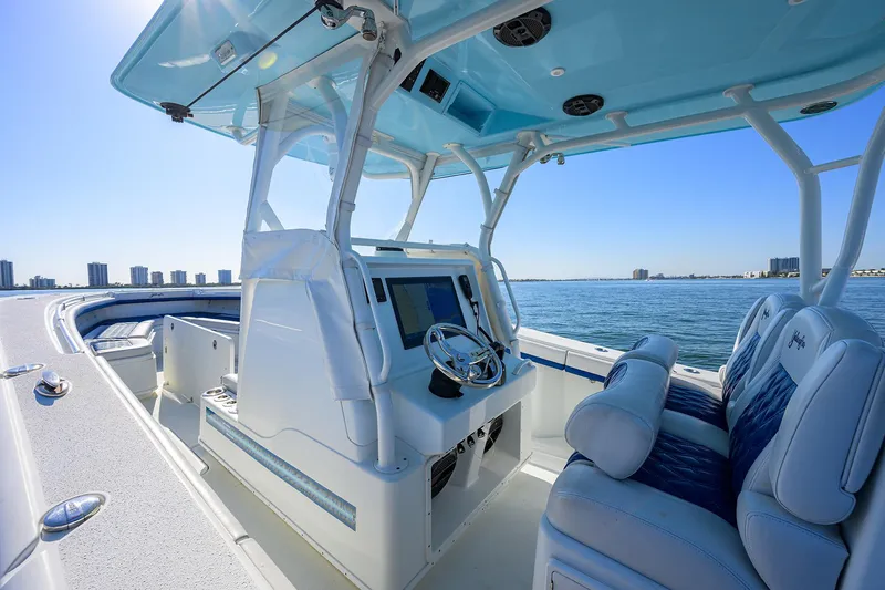 Slide: The Image of 2019 Yellowfin 34 Center Console boat interior with blue seating and ocean view. - 23