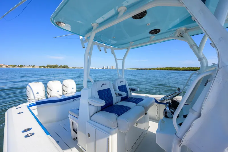 Slide: The Image of 2019 Yellowfin 34 Center Console boat on calm water, featuring spacious seating and multiple engines. - 26