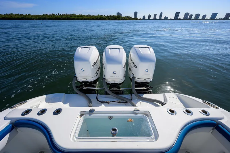 Slide: The Image of 2019 Yellowfin 34 Center Console boat with triple outboard engines on calm water. - 32