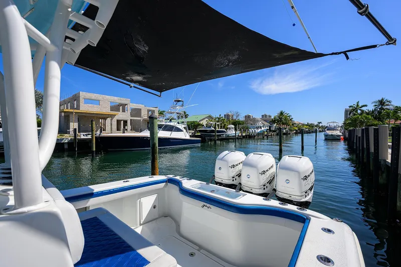 Slide: The Image of 2019 Yellowfin 34 Center Console boat docked with triple outboard engines. - 35