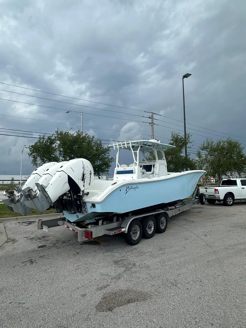 Slide: The Image of 2019 Yellowfin 34 Center Console boat on trailer, parked near a white truck. - 37