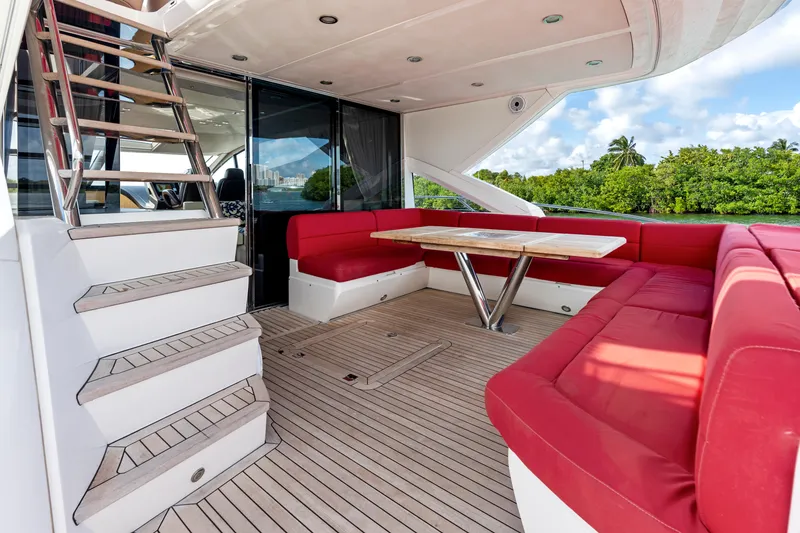Slide: The Image of Luxurious 2014 Sunseeker 68 Sport Yacht deck with red seating and wooden flooring. - 15