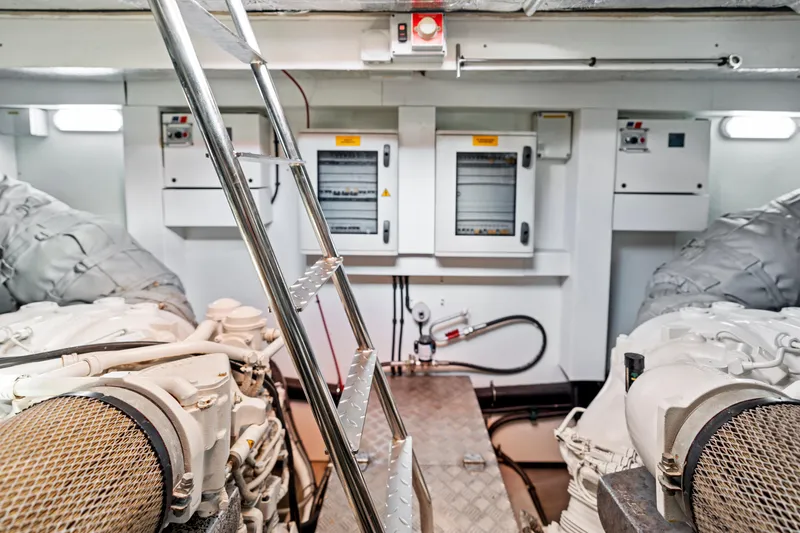 Slide: The Image of Engine room of a 2014 Sunseeker 68 Sport Yacht, featuring control panels and machinery. - 24