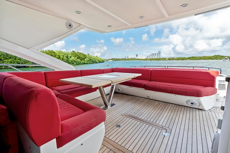Slide: The Image of Luxurious 2014 Sunseeker 68 Sport Yacht with red seating and scenic water view. - 34