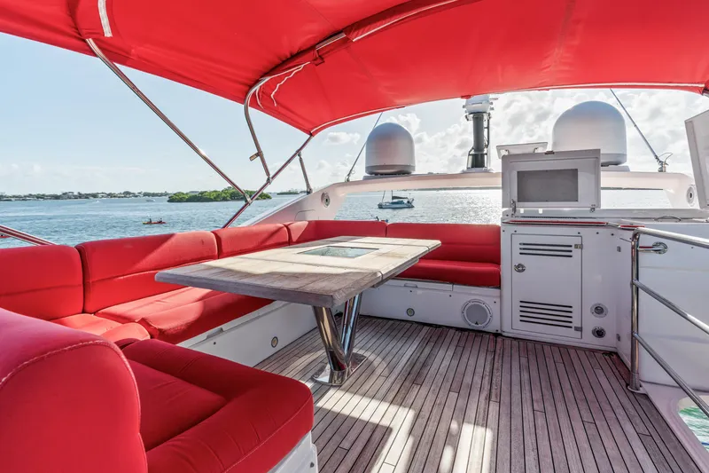 Slide: The Image of Luxurious 2014 Sunseeker 68 Sport Yacht with red seating and ocean view. - 40