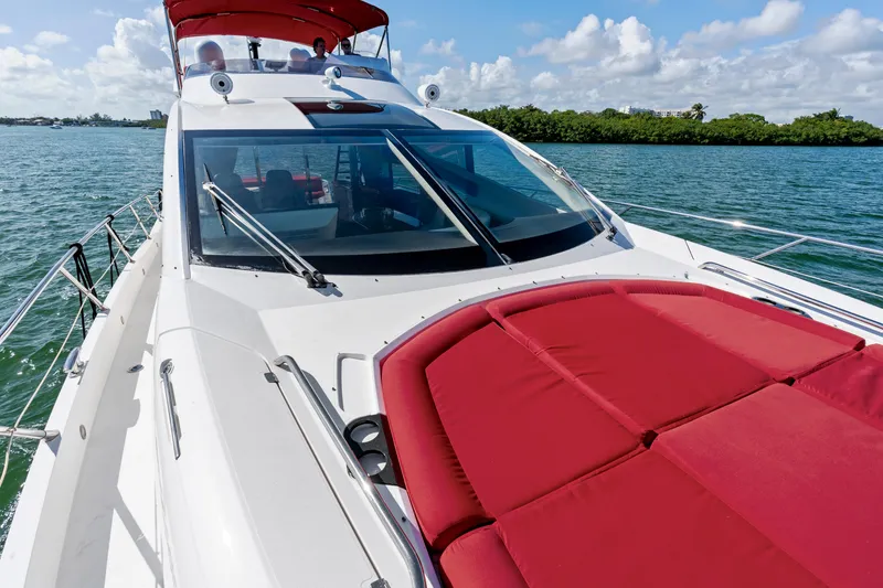 Slide: The Image of 2014 Sunseeker 68 Sport Yacht with red sunbed, cruising on a sunny day. - 44