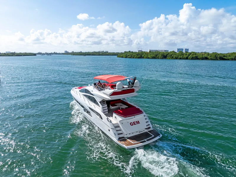 Slide: The Image of 2014 Sunseeker 68 Sport Yacht cruising on open water under a clear blue sky. - 6