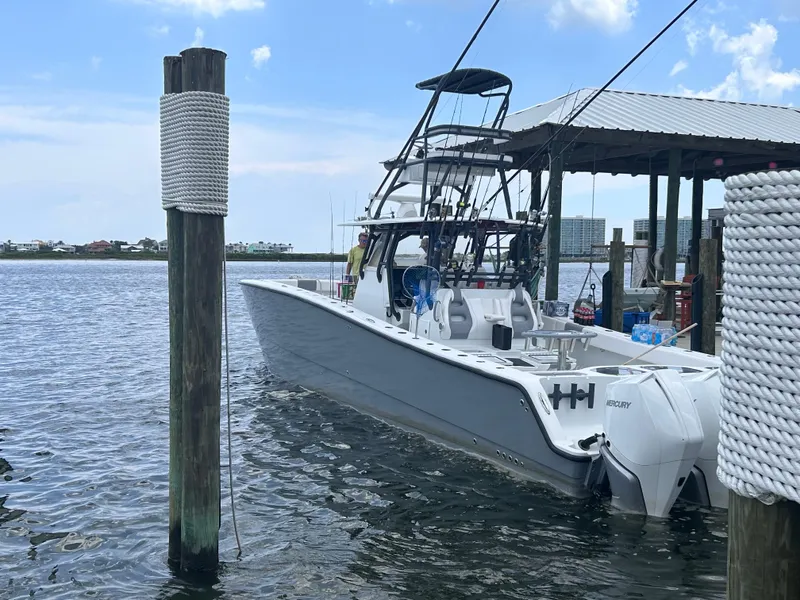 Slide: The Image of 2018 Freeman 42LR boat docked at marina, calm waters, clear sky. - 3