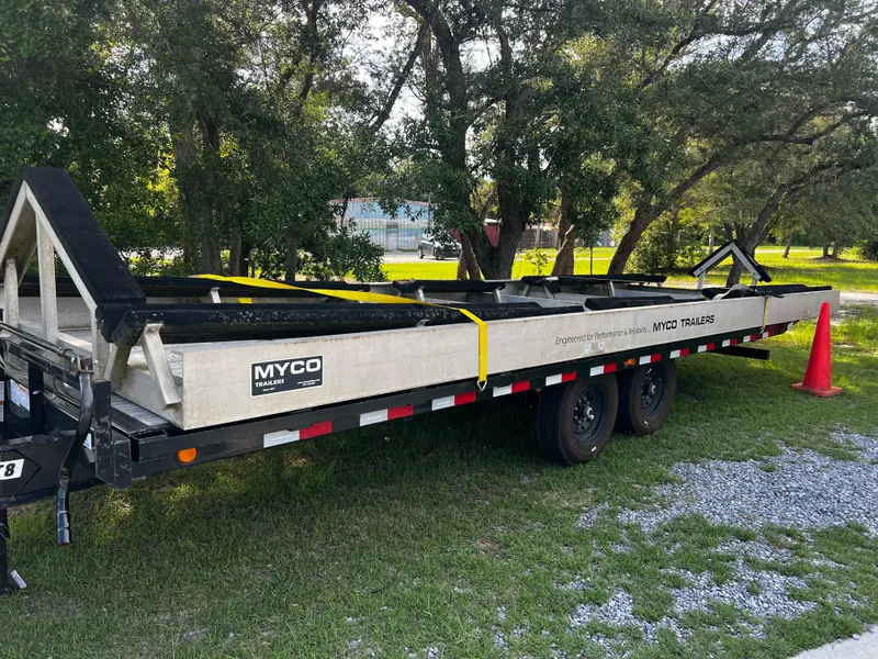 Slide: The Image of Trailer for Freeman 42LR 2018, parked on grass, with Myco branding and safety cone nearby. - 4