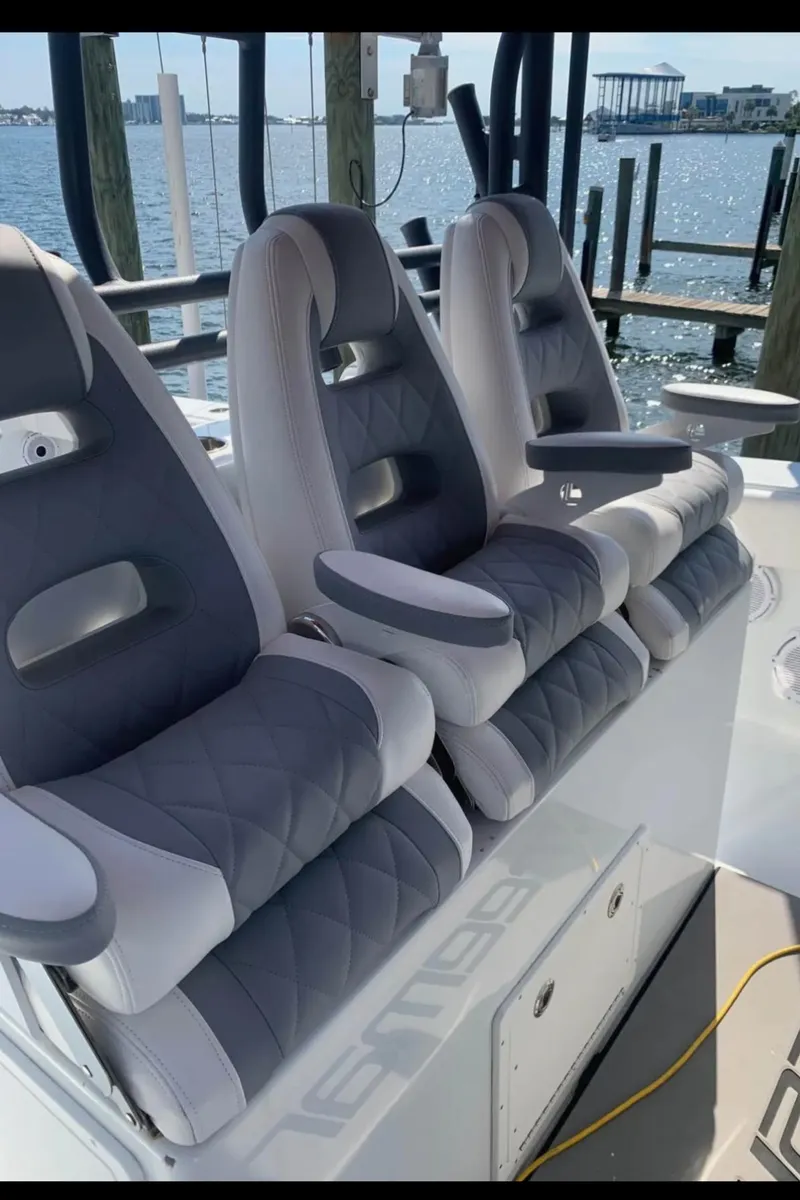Slide: The Image of Luxury seating on a 2018 Freeman 42LR boat, docked by the water. - 9