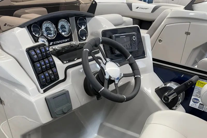 The Image of 2025 Starcraft SLS 3 Q DH boat dashboard with steering wheel and control panel. - 0