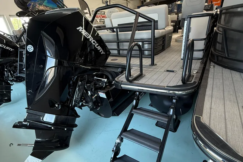 Slide: The Image of 2025 Starcraft SLS 3 Q DH pontoon boat with Mercury outboard motor and boarding ladder. - 2