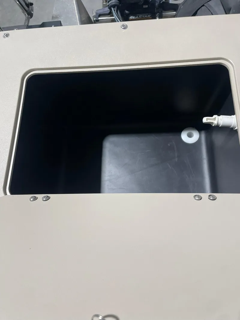 Slide: The Image of 2019 Avalon Lsz Rear Fish 24' storage compartment with open lid and visible interior. - 13