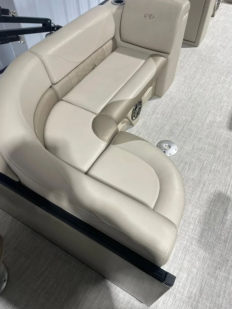 Slide: The Image of 2019 Avalon Lsz Rear Fish 24' boat interior with beige seating and carpeted flooring. - 14