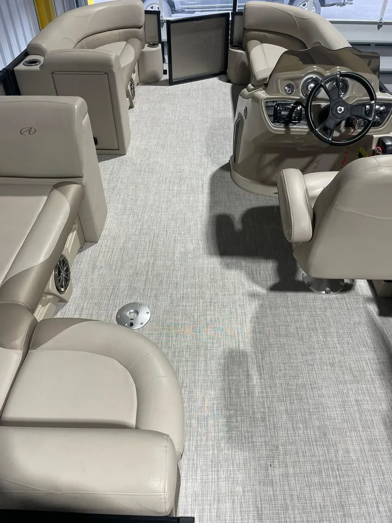 Slide: The Image of 2019 Avalon Lsz Rear Fish 24' boat interior with beige seating and steering console. - 15