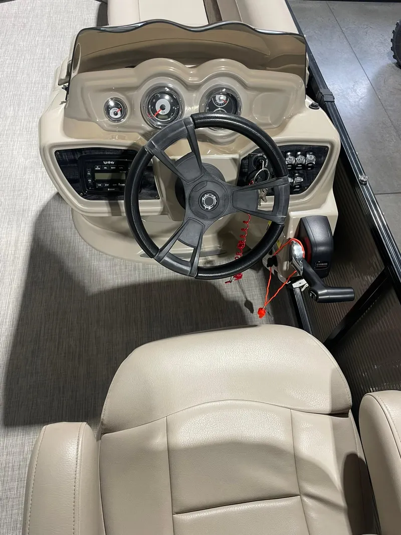 Slide: The Image of 2019 Avalon Lsz Rear Fish 24' boat dashboard with steering wheel and controls. - 17