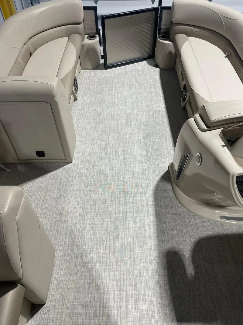 Slide: The Image of 2019 Avalon Lsz Rear Fish 24' boat interior with beige seating and carpeted floor. - 18